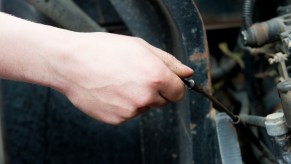 Checking the oil level in a vehicle engine using a dipstick