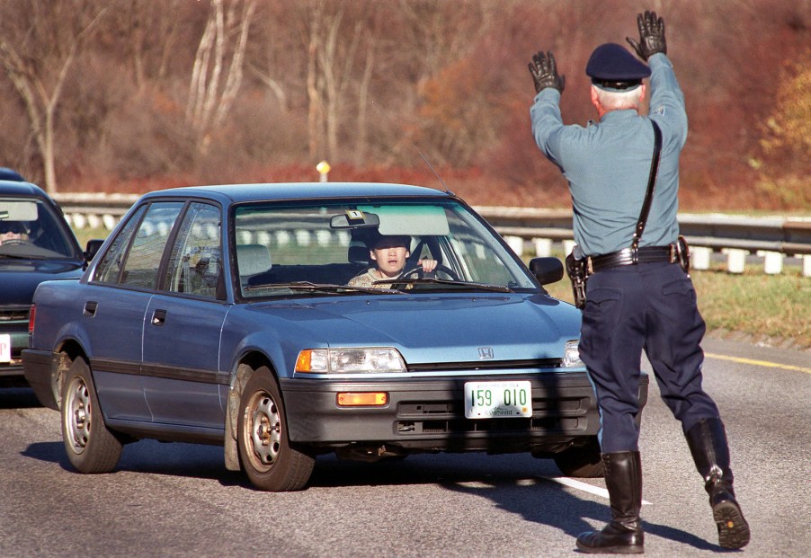 A driver attempts to skirt around Trooper Paul Pierce, who was trying to pull her over for driving in the breakdown lane on Rt. 3 near I-495 in Chelmsford. Trooper Pierce is part of the 3D unit cracking down on aggressive driving.