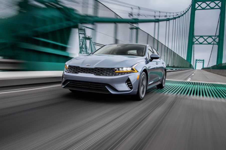 2021 Kia K5 driving across a bridge