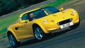 A yellow 1996 Lotus Elise S1 on a racetrack