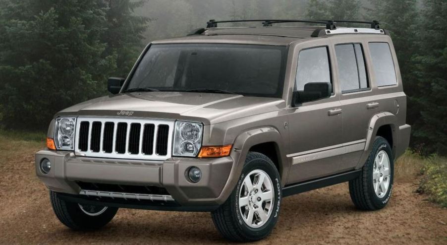 A tan 2008 Jeep Commander in the woods