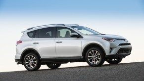 A silver 2017 Toyota RAV4 parked on display in front of a blue sky