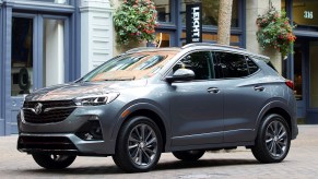 A blue 2020 Buick Encore GX parked next to a building