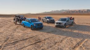 Three Ford F-150 Lariat XLT pickup trucks parked in a desert. The F-150 is part of Ford's F-Series of trucks.