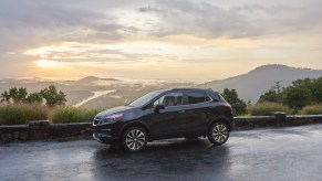 A black 2021 Buick Encore on display in front of mountain range