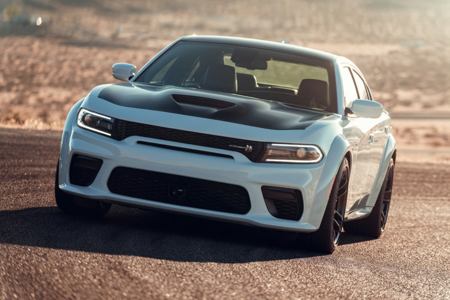 A white and black 2021 Dodge Charger driving on a track