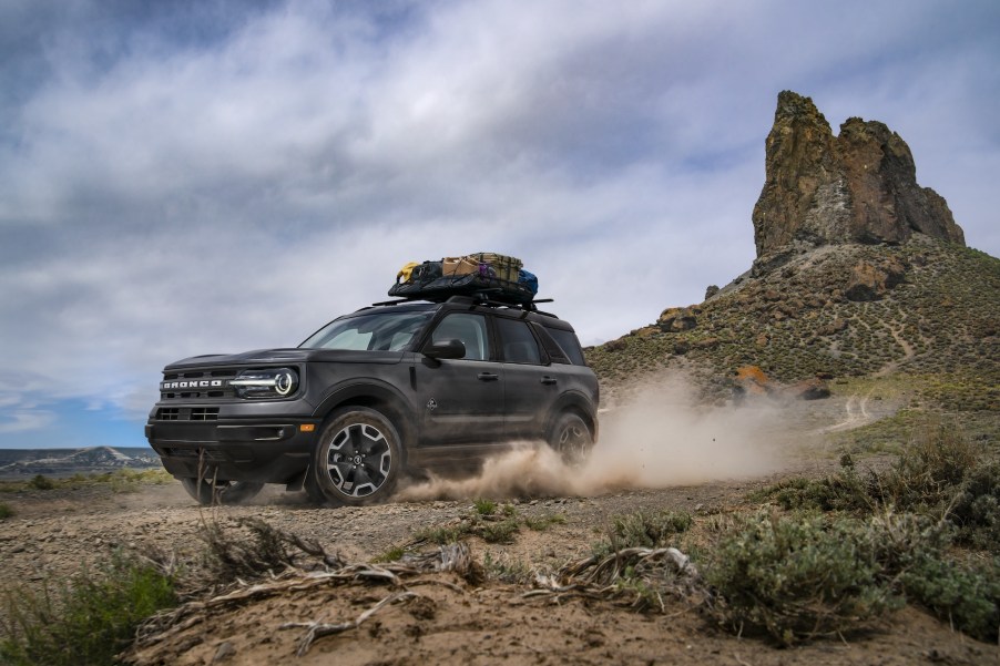 A 2021 Ford Bronco Sport Outer Banks in Carbonized Gray drives through a desert