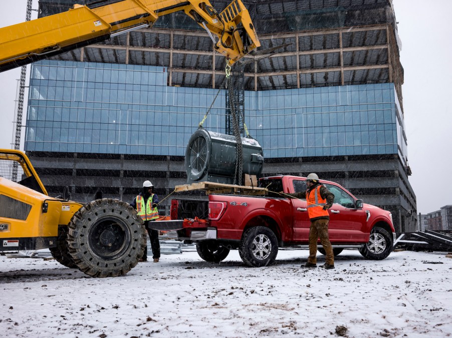 A dark-red 2021 Ford F-150 on a construction site