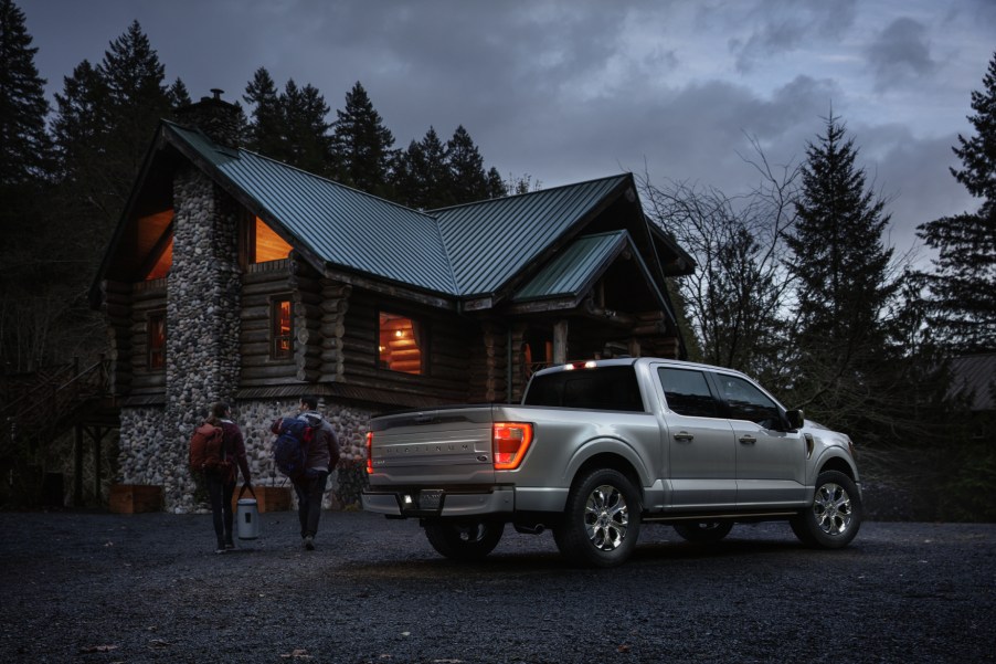 A silver 2021 Ford F-150 Platinum parked in front of a country house