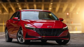 A red 2021 Hyundai Elantra sedan parked in a lit hangar