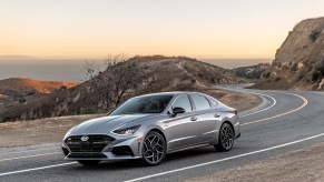 a gray 2021 hyundai sonata driving on a winding mountain road