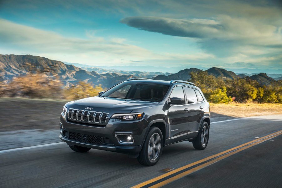 2021 Jeep® Cherokee Limited driving down a sunlit roadway