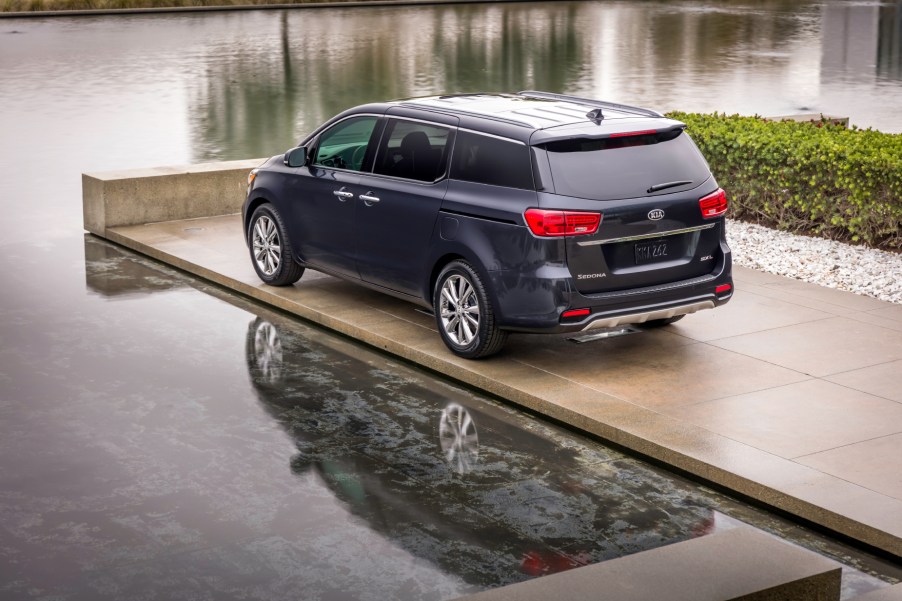 A black 2021 Kia Sedona parked next to the water