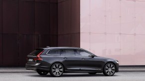 The rear 3/4 view of a dark-gray 2021 Volvo V90