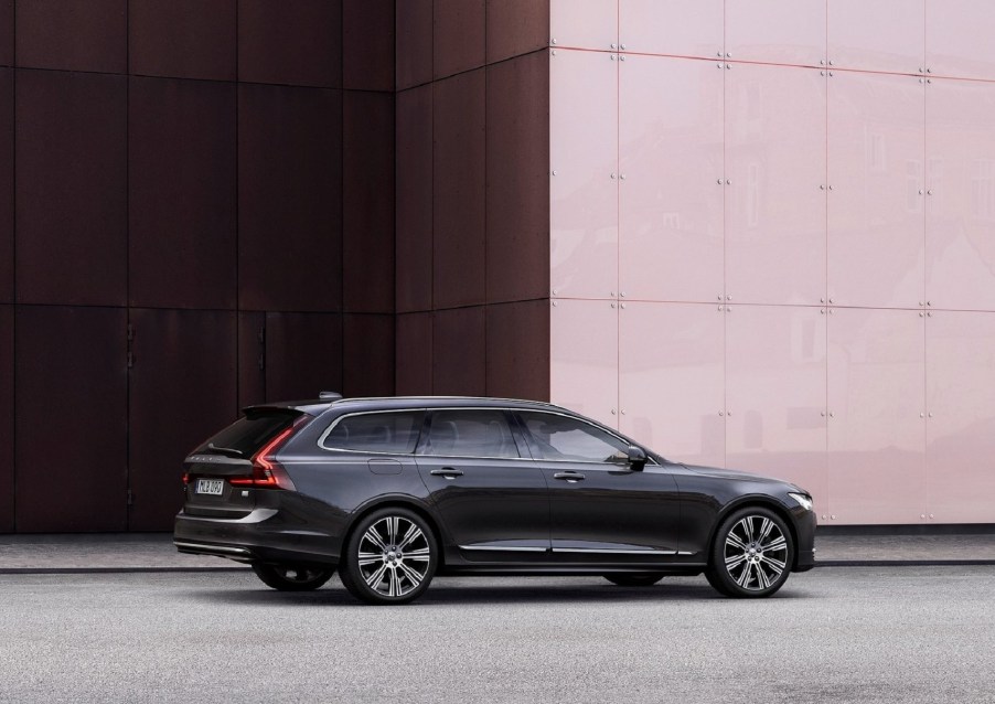 The rear 3/4 view of a dark-gray 2021 Volvo V90