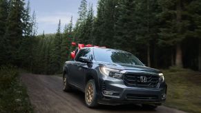 a honda ridgeline at speed on a dirt road