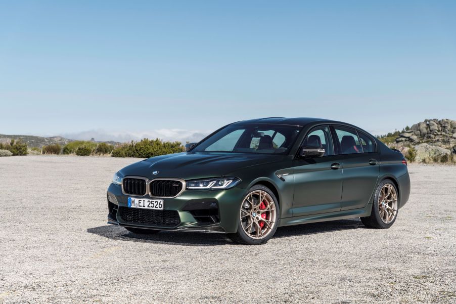 A matte-green 2022 BMW M5 CS in the desert