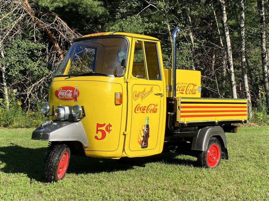 A modified yellow Coca-Cola-liveried 1980 Piaggio Ape