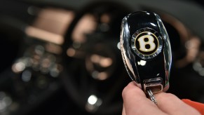 A Bentley key fob in someone's hand