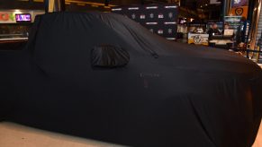 Brantley Gilbert's Speedcore Ford F150 is held under a car cover before unveiling at Bridgestone Arena Plaza