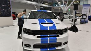 A worker readies a Dodge Durango SRT for exhibit at the 2020 New England Auto Show Press Preview