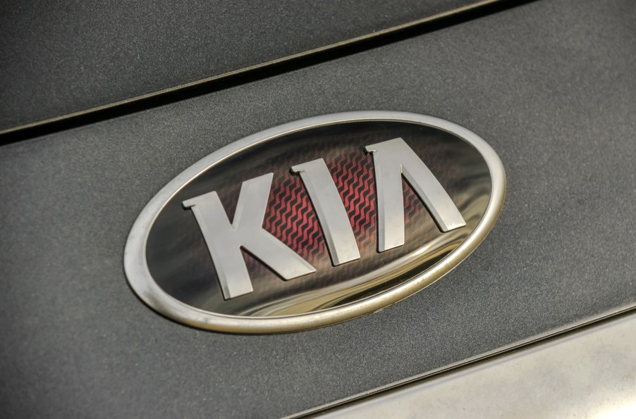 A close-up look at the Kia Logo on a black 2020 Kia K900