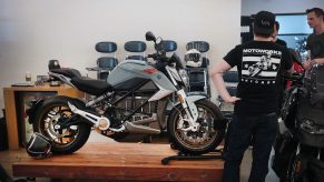 A motorcycle shopper checks out a bike on display