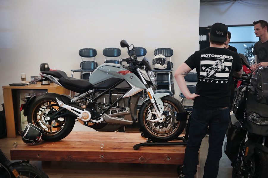 A motorcycle shopper checks out a bike on display