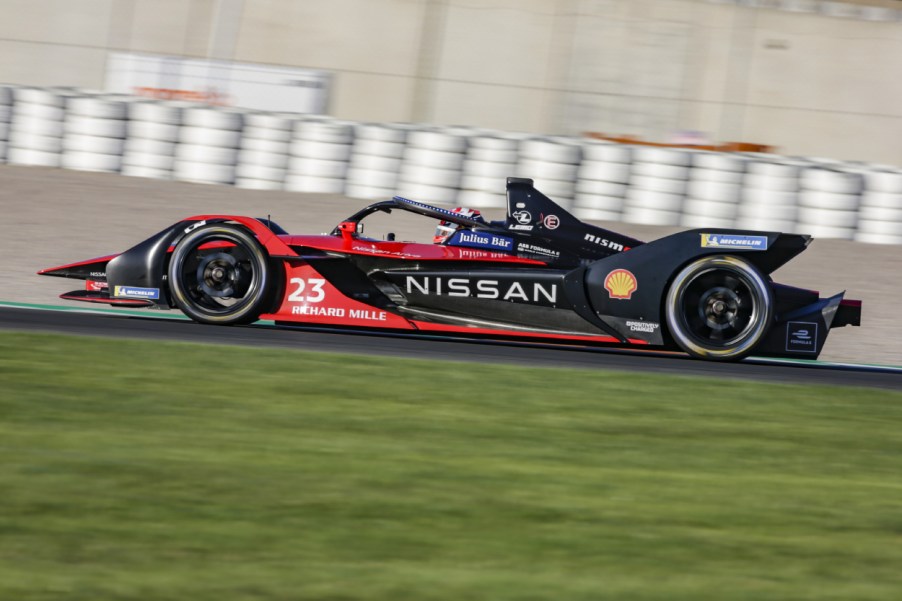 A Nissan racecar speeds down the track