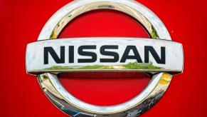 Silver Nissan logo on a red vehicle