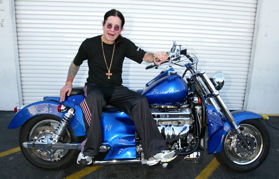 Ozzy Osbourne sits on a motorcycle