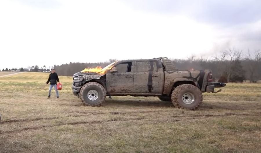 An image of a broken 2021 Ram 1500 TRX on enormous tires off-road.