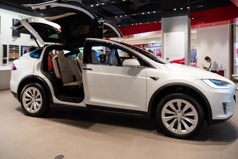 A white Tesla Model X electric SUV seen in a showroom