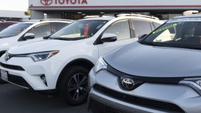 Toyota RAV4 SUVs on display at a a car dealership