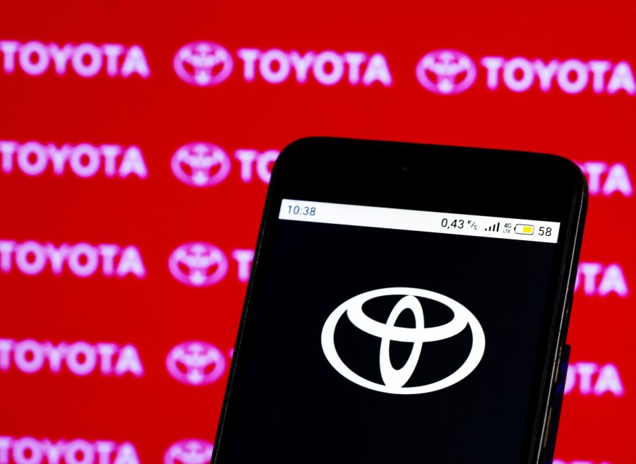 In this photo illustration, a Toyota logo seen displayed on smartphone