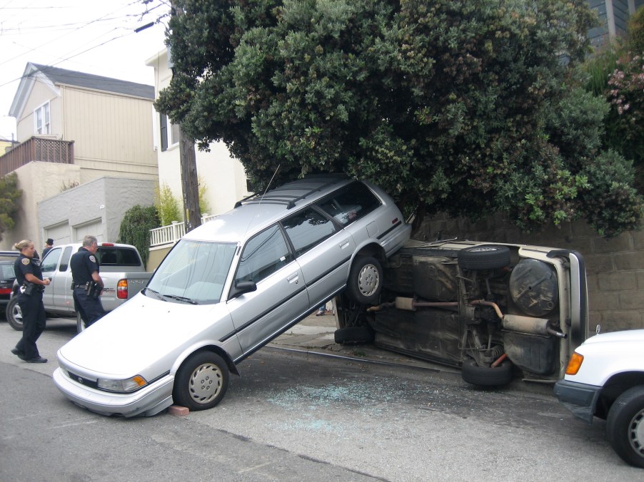 A silver station wagon reversing out of a driveway in August 2006 struck a 2002 BMW and overturned it