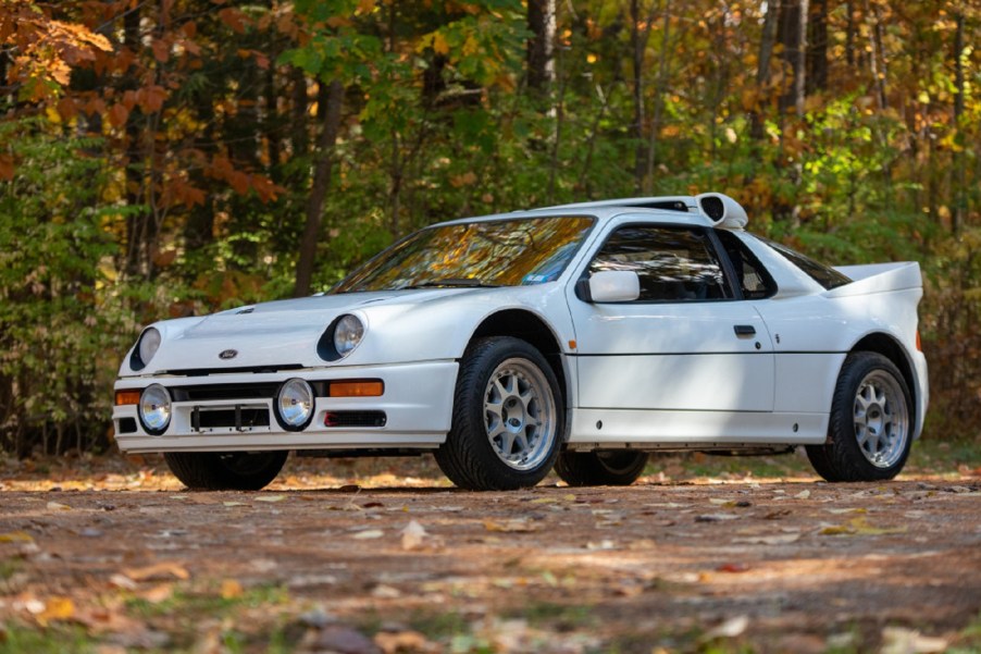 A white 1986 Ford RS200 Evolution in the forest