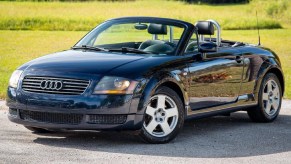 A black 2002 Audi TT Roadster with its roof down