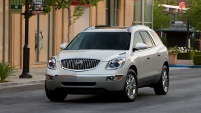 A white 2012 Buick Enclave luxury crossover SUV stopped on a city street