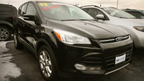 A black 2013 Ford Escape compact SUV sits at a dealership on November 26, 2013, in Niles, Illinois