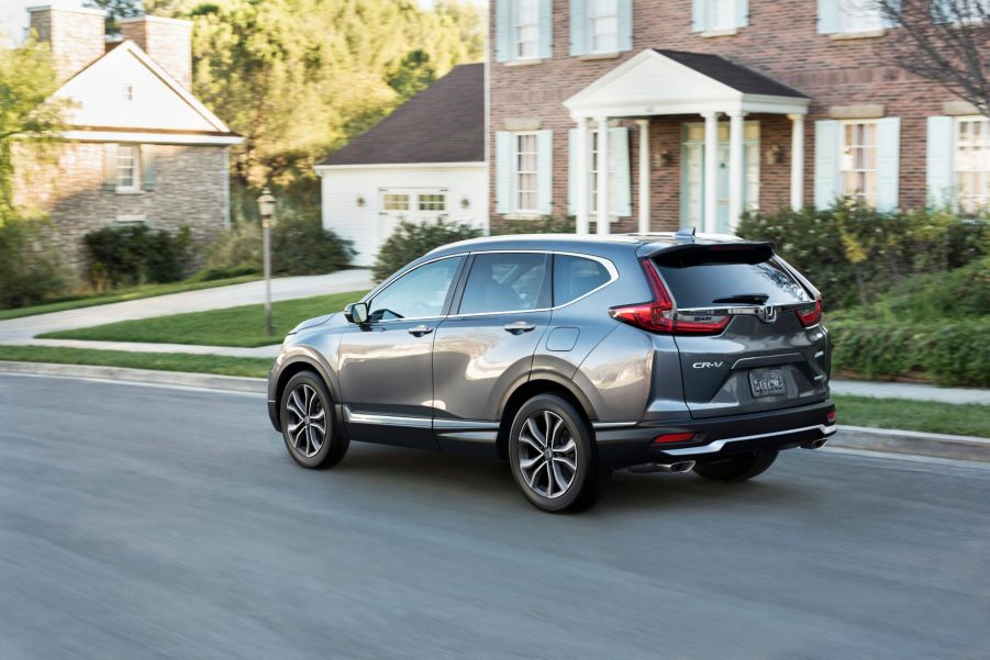 A grey 2020-2021 Honda CR-V Touring driving down a residential street