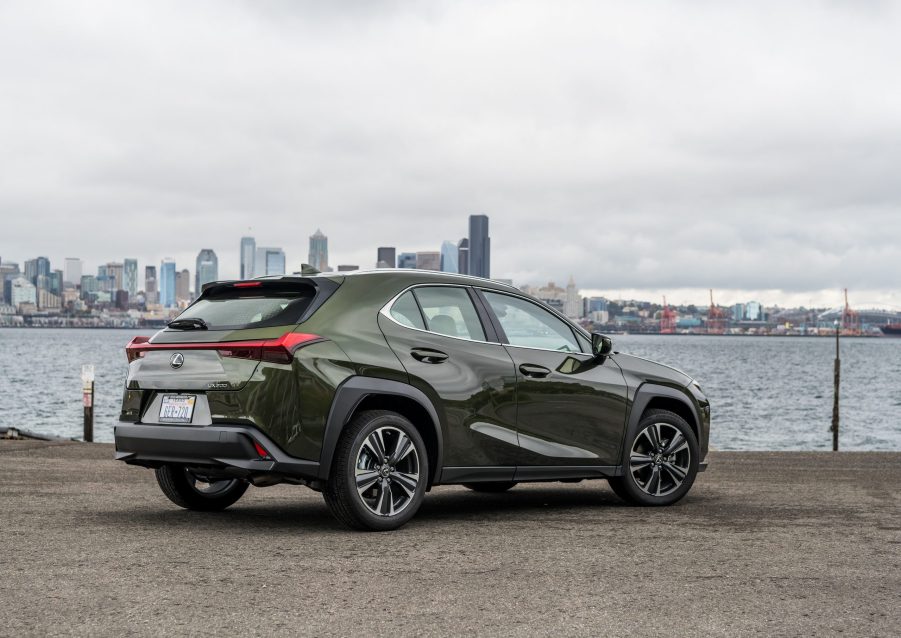 The rear of the Nori Green 2020 Lexus UX overlooking a city skyline and a river