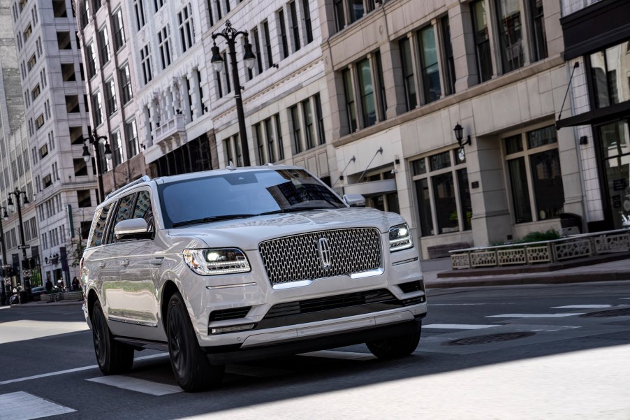 A white 2020 Lincoln Navigator Reserve full-size SUV stopped in a crosswalk on a city street