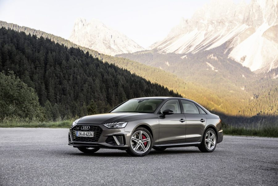 A grey 2021 Audi A4 sedan parked in front of a mountain