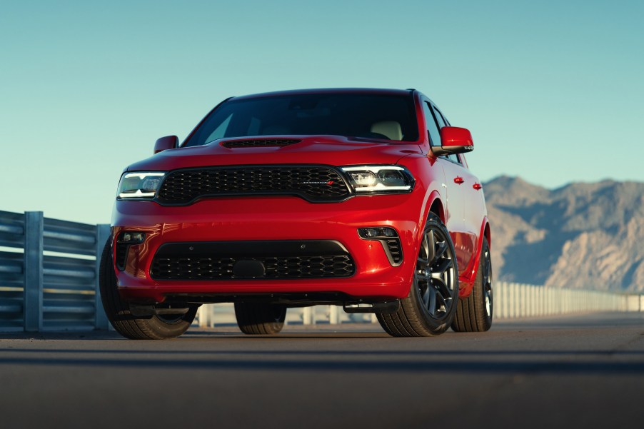 A red 2021 Dodge Durango R/T parked on asphalt in front of mountains