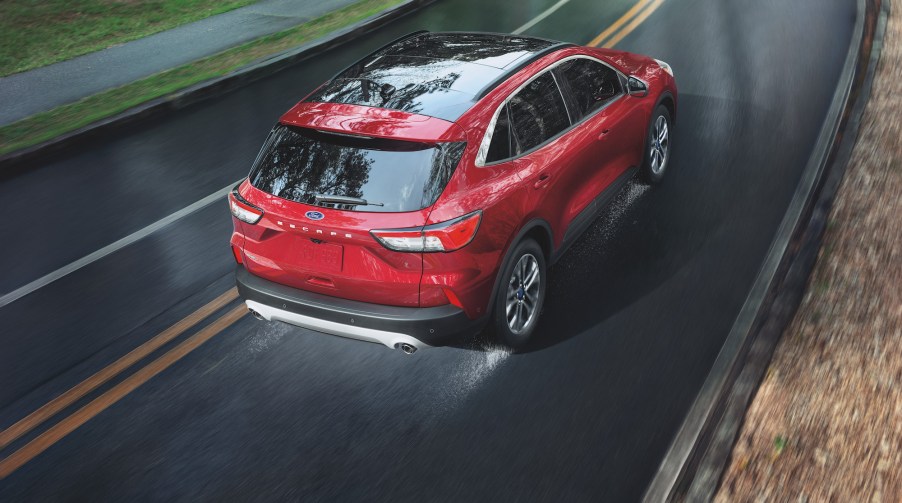 An overhead shot of a red 2021 Ford Escape SEL EcoBoost compact crossover SUV traveling on a wet road