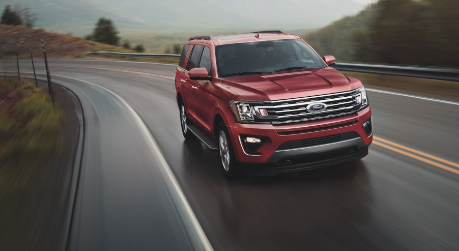 The 2021 Ford Expedition driving down an empty road.