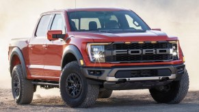 An orange 2021 Ford F-150 Raptor in the desert