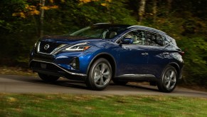 A blue 2021 Nissan Murano driving down a country road