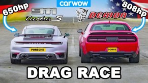 A silver 2021 Porsche 911 Turbo S next to a red 2018 Dodge Challenger SRT Demon on an airstrip